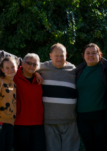 Family photo featuring a grandmother, grand father and several grandchildren